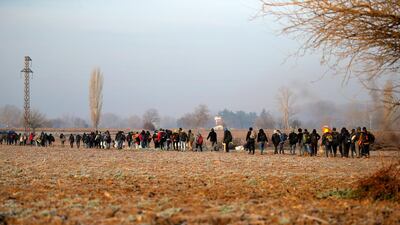 Migrants walk to reach Pazarakule border gate, Edirne, Turkey, at the Turkish-Greek border. Turkey's President Recep Tayyip Erdogan said his country's borders with Europe were open Saturday, making good on a longstanding threat to let refugees into the continent as thousands of migrants gathered at the frontier with Greece. AP