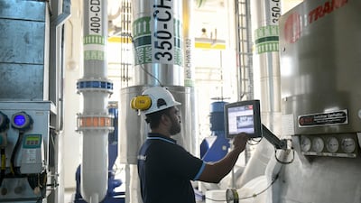 An engineer adjusts the settings at a Tabreed district cooling plant in Abu Dhabi. All photos: Khushnum Bhandari / The National