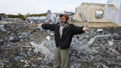 A Palestinian man gestures as he inspects the scene of an Israeli air strike in Rafah, Gaza Strip. Ibraheem Abu Mustafa / Reuters / March 14, 2014
