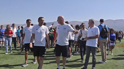 Fifa President Gianni Infantino speaks with Youri Djorkaefs. AFP
