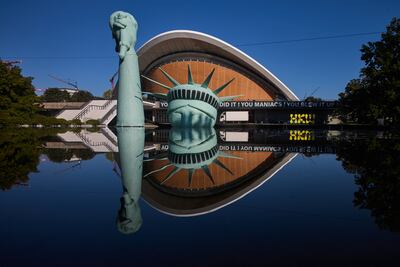 An inflatable Statue of Liberty floats in a pool outside the Haus der Kulturen der Welt museum in Berlin. AP
