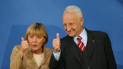 Edmund Stoiber, then CDU-CSU chancellor candidate, and Angela Merkel, CDU president, celebrate that their coalition is leading in the first returns in the general election at CDU headquarters in Berlin. September 22, 2002. AFP