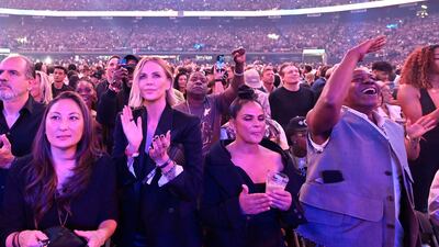 Actress Charlize Theron, front row middle left, comedian Dave Chappelle, front row right, and actor Tracy Morgan, middle rear, stand at ringside. AP