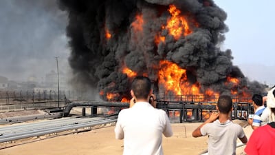 Smoke rises from an oil tank set on fire by rebel shelling of the Aden oil refinery in southern Yemen on 27 June, 2015. EPA
