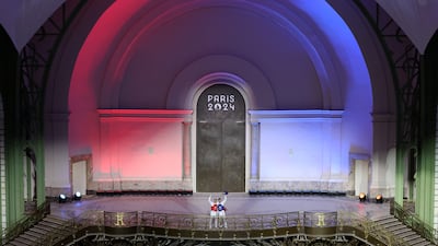Ulugbek Rashitov of Team Uzbekistan (blue) and Zaid Kareem of Team Jordan (red) acknowledge the fans ahead of their bout. Getty Images