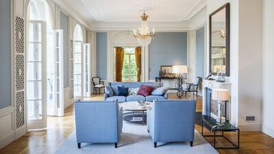 The sitting room opens on to a terrace with steps leading down to a rose garden. Courtesy 16elements Architekturfotografie via Savills International
