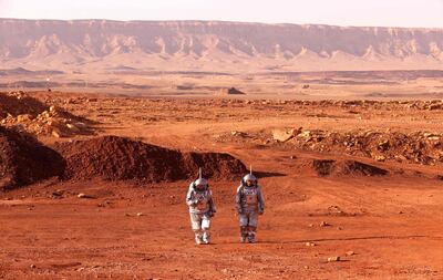 Scientists walk in spacesuits during a training mission for Mars in Israel's southern Negev desert. AFP