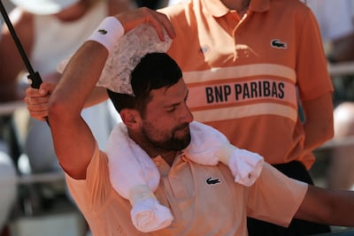Novak Djokovic uses an ice bag to cool down at Roland Garros. AFP