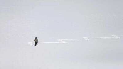 An Afghan man carries boiled eggs for sale on snow covered Qargha Lake in Kabul, Afghanistan. Reuters