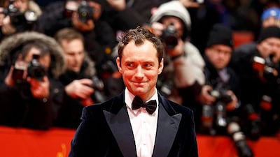 Actor Jude Law poses on the red carpet as he arrives for the screening of the movie "Side Effects" at the 63rd Berlinale International Film Festival in Berlin February 12, 2013. REUTERS/Thomas Peter (GERMANY - Tags: ENTERTAINMENT)