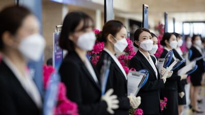 Event staff wear protective masks during the Samsung Electronics Co. annual general meeting at the Suwon Convention Centre in Suwon, South Korea. Bloomberg