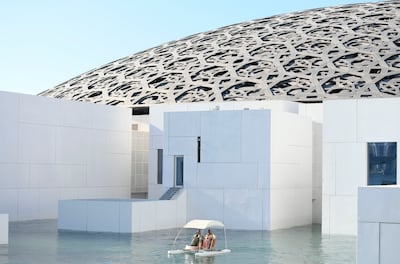 Visitors enjoy a catamaran ride around Louvre Abu Dhabi. Khushnum Bhandari / The National