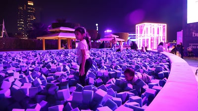 Children play inside a foam pit