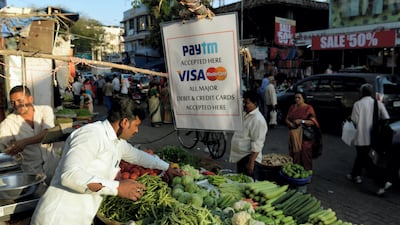 Many traders in India were badly bruised by Narendra Modi’s demonetisation move. The owner of this vegetable stall in Mumbai has adapted by adopting cashless payment. PUNIT PARANJPE/AFP