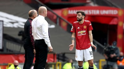 Manchester United's Bruno Fernandes speaks to Burnley manager Sean Dyche during the match. PA