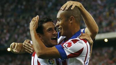 Atletico Madrid's Miranda, right, celebrates his goal against Eibar with teammate Koke during their La Liga win on Saturday. Andrea Comas / Reuters / August 30, 2014
