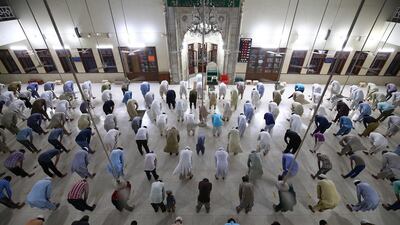 Men at a mosque maintain distance during a lockdown of Sindh province, in Karachi, Pakistan, 19 April 2020. Shahzaib Akber/ EPA