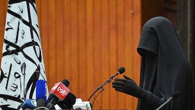 A veiled student speaks to a gathering of female students before a pro-Taliban rally. AFP