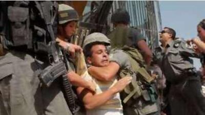 Israeli police officers detain a Palestinian protester during a demonstration against the construction of a separation barrier in the West Bank village of Walajeh this week.