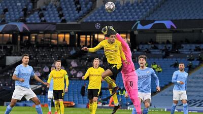 City goalkeeper Ederson punches the ball away from the head of Dortmund midfielder Mahmoud Dahoud at the Etihad Stadium. AFP