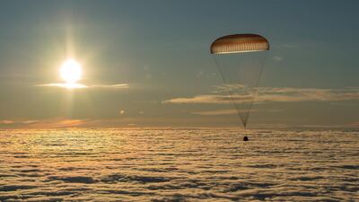 The Soyuz MS-06 capsule carrying the crew of Joe Acaba and Mark Vande Hei of the US, and Alexander Misurkin of Russia descends beneath a parachute just before landing in a remote area outside the town of Dzhezkazgan (Zhezkazgan), Kazakhstan. Bill Ingalls / NASA / Handout via Reuters
