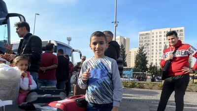 A Syrian boy gestures as he waits to leave for Syria with his family at the Esenyurt Municipality garden in Istanbul, Turkey. Emrah Gurel for The National