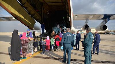 Children of suspected ISIS fighters board a Russian plane at the runway of Baghdad International Airport. EPA