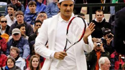 Switzerland's Roger Federer walks on to the court at Wimbledon.