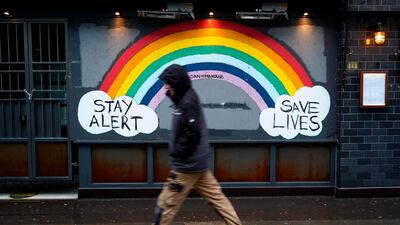 A pedestrian walks past a closed business in Soho in London. AFP