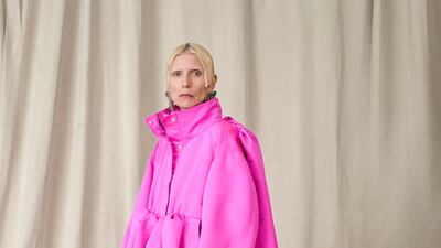 Balenciaga's famous baby doll dress was updated as a satin funnel-necked parka in shocking pink.