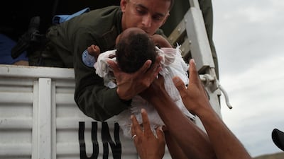 UN peacekeepers evacuating more than 1,000 of the most vulnerable residents of the Corail-Cesselesse relocation camp before Tropical Storm Tomas makes landfall in Port au Prince, Haiti in 2010. Getty Images
