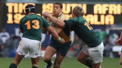Timana Tahu is tackled by Adrian Jacobs, left, and Jean de Villiers during the 2008 Tri Nations match against South Africa.