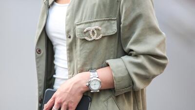 May Berthelot (Head of Legal at Videdressing.com - @maymaryb), is wearing a Chanel boy bag, a Chanel brooch, a Zara green jacket, an H&M white top. Edward Berthelot / Getty Images
