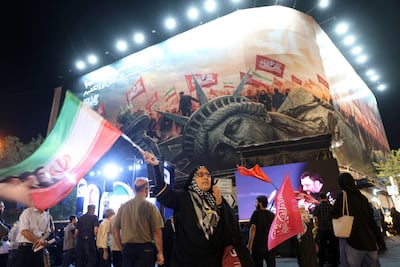 Iranians demonstrate against the US near an anti-American billboard in Tehran, Iran, on Wednesday. EPA