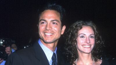 Julia Roberts, in a classic LBD, and Benjamin Bratt attend the 'Notting Hill' premiere at the Zeigfeld Theatre in New York, US, on May 13, 1999. Getty Images
