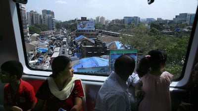 Commuters ride on a train. Metro I will reduce travel time on the 12-kilometre Versova-Andheri-Ghatkopar corridor to 21 minutes as against one hour that it takes to cover the stretch by road. Rafiq Maqbool / AP Photo