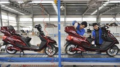 Employees work at the assembly line of an electric bike facgtory in Hefei, Anhul province.