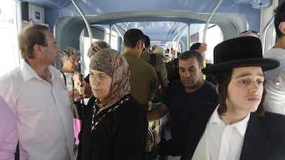 Israelis and Palestinians from East Jerusalem ride the new-light rail system through the holy city. AFP Photo/Ahmad Gharabli