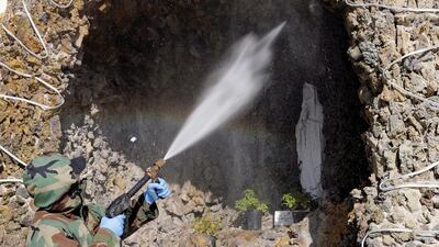 A member of a civil defence team sprays disinfectant on a statue at the Our Lady of Salvation church to prevent the spread of the coronavirus disease. Reuters