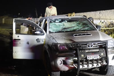 Security personnel inspect a damaged vehicle at the site of the explosion in Quetta. AFP