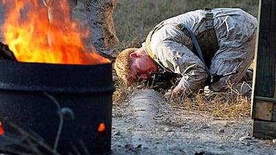 A student examines the scene of a mock suicide bombing during an exercise at the US Army John F Kennedy Special Warfare Center and School at Fort Bragg in October.