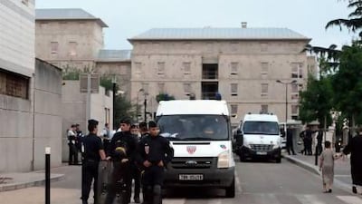 French riot police stand guard in front of the police station in Trappes, a suburb of Paris, after violence erupted after police carried an identity check on a woman wearing a niqab.