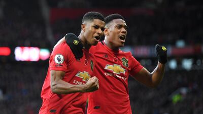 Marcus Rashford of Manchester United celebrates with teammate Anthony Martial after scoring his team's third goal against Brighton and Hove Albion at Old Trafford on Sunday. Getty Images