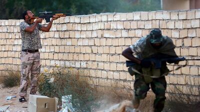 Members of Libya's Shield Brigade clash with gunmen accused of being loyal to the former Qaddafi regime. Mahmud Turkia / AFP