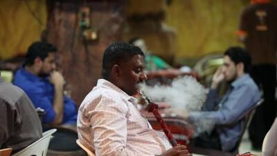 People enjoy shisha at Al Sindibad Coffee Shop & Cafeteria in the Nuaimiya area in Ajman.