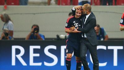 Bayern Munich manager Pep Guardiola embraces Mario Gotze after the team's Champions League victory over Olympiakos on Wednesday night. Alex Grimm / Bongarts / Getty Images