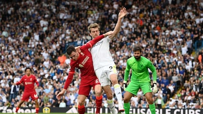 Liverpool's Andrew Robertson holds off the challenge of Leeds attacker Patrick Bamford. Getty