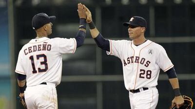 Houston's Ronny Cedeno high fives Rick Ankiel after the final out against the Texas Rangers.