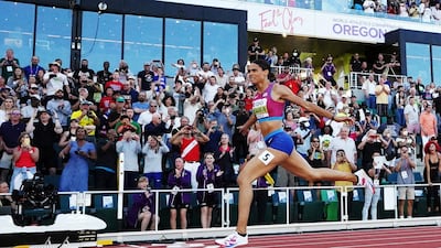 Sydney McLaughlin crosses the line to win the women's 400m hurdles final and set a world record. Reuters