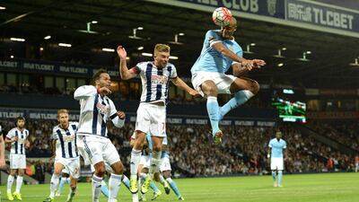 Manchester City defender Vincent Kompany, rught, heads past West Brom midfielder James Morrison to score his team’s third. Oli Scarff / AFP / August 11, 2015